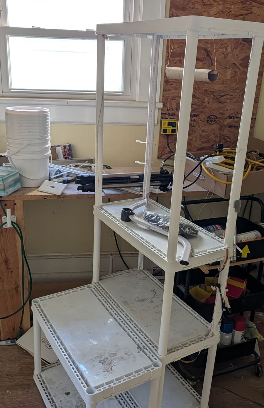 Before: a bedroom full of shelving, buckets, and stored tools